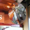 Convex Security Mirror fixed in a retail setting showing customers in the reflection.